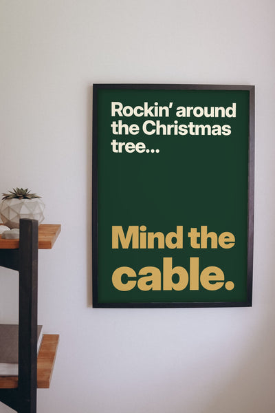 Funny Rockin' Around the Christmas Tree lyric print framed on a wall