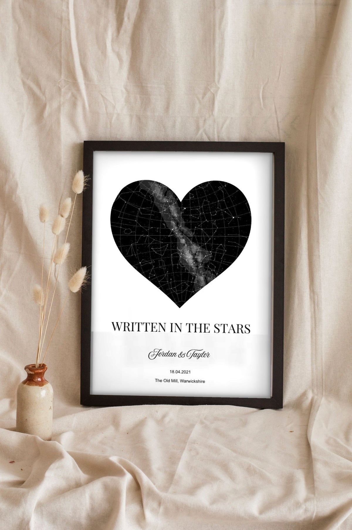 Lifestyle - Personalised Star Map Heart Print leaning in a frame with dried flowers