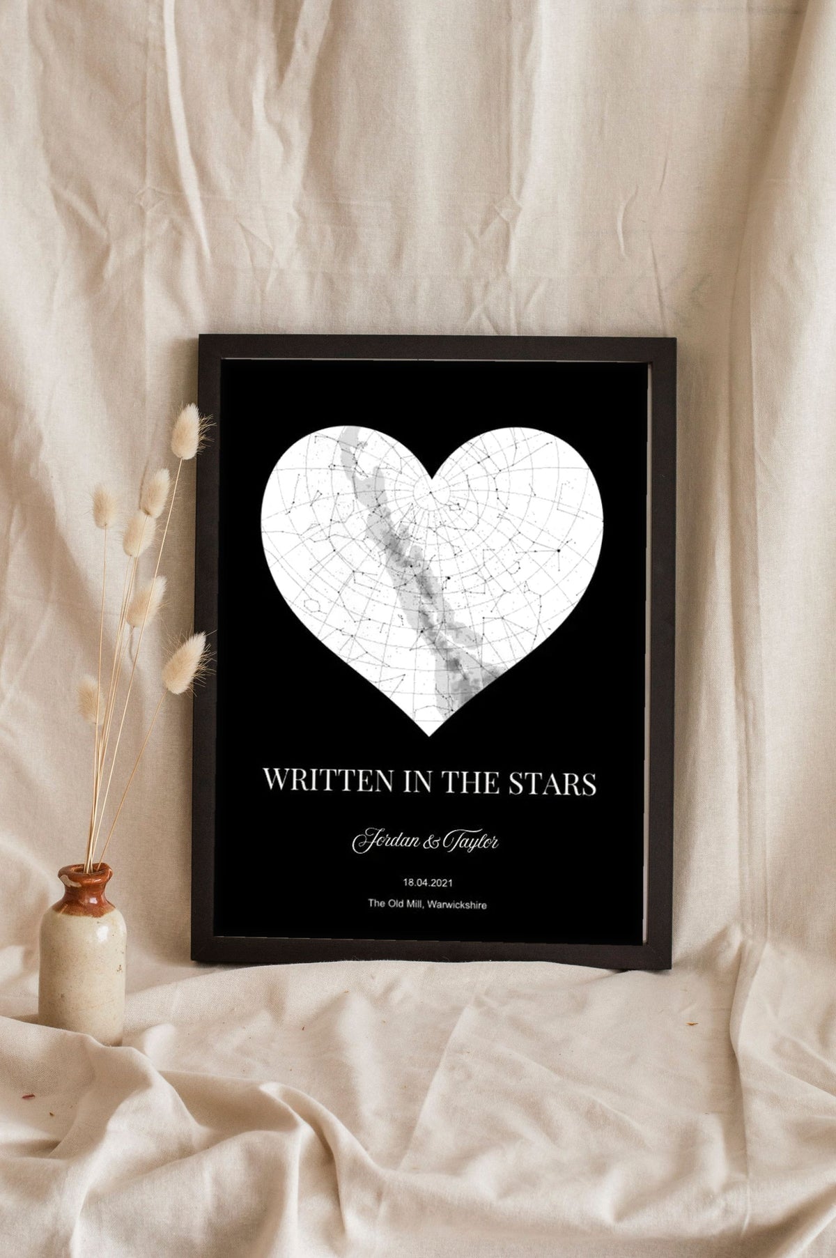Lifestyle - Personalised Heart Star Map Print leaning in a frame with dried flowers