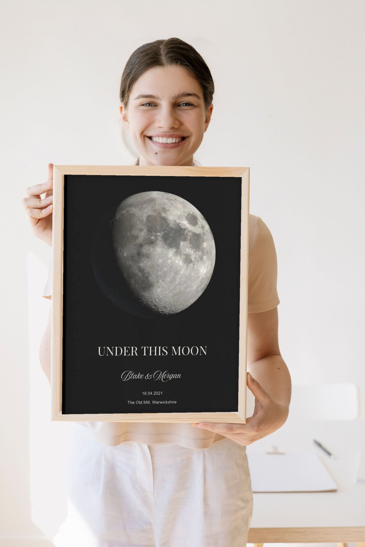 Lifestyle - Personalised Moon Phase Print held by a smiling woman