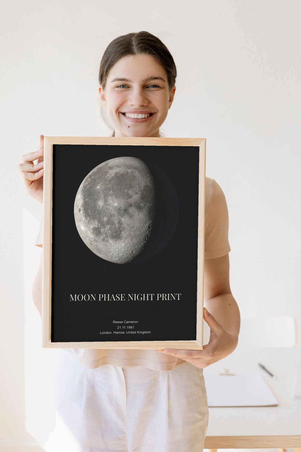 Lifestyle - Personalised Moon Phase Print held by a smiling woman