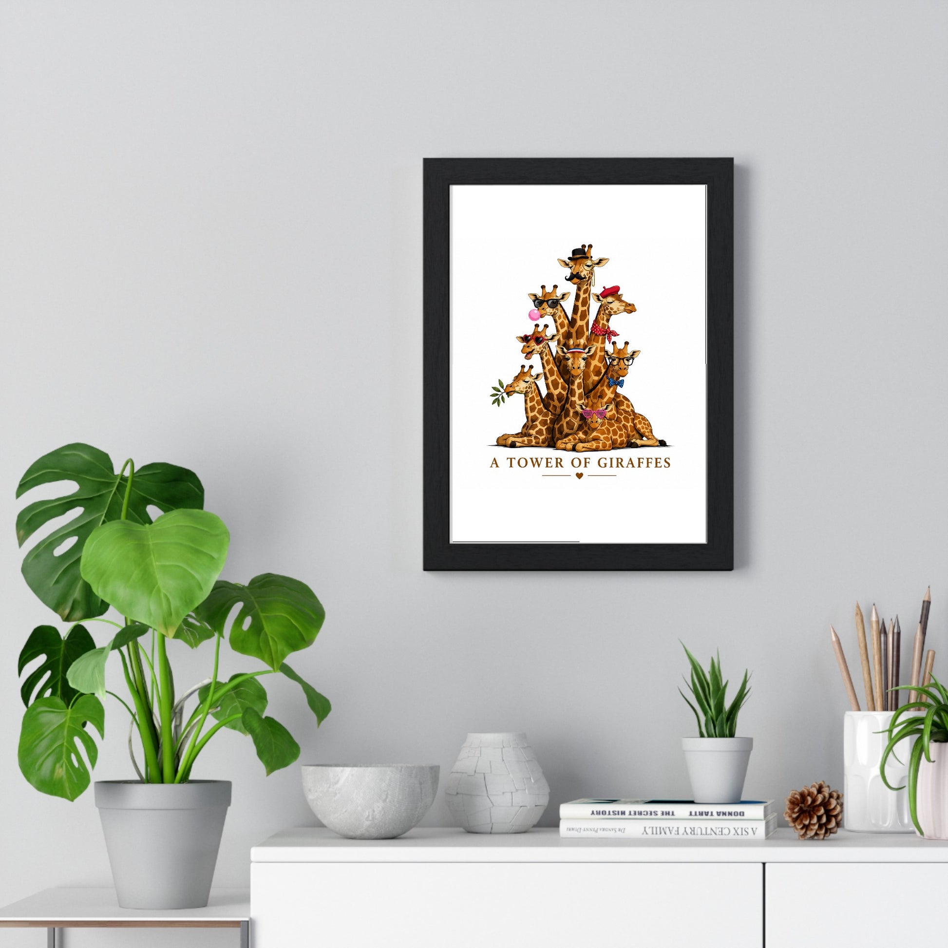 A Tower of Giraffes framed poster displayed on living room wall