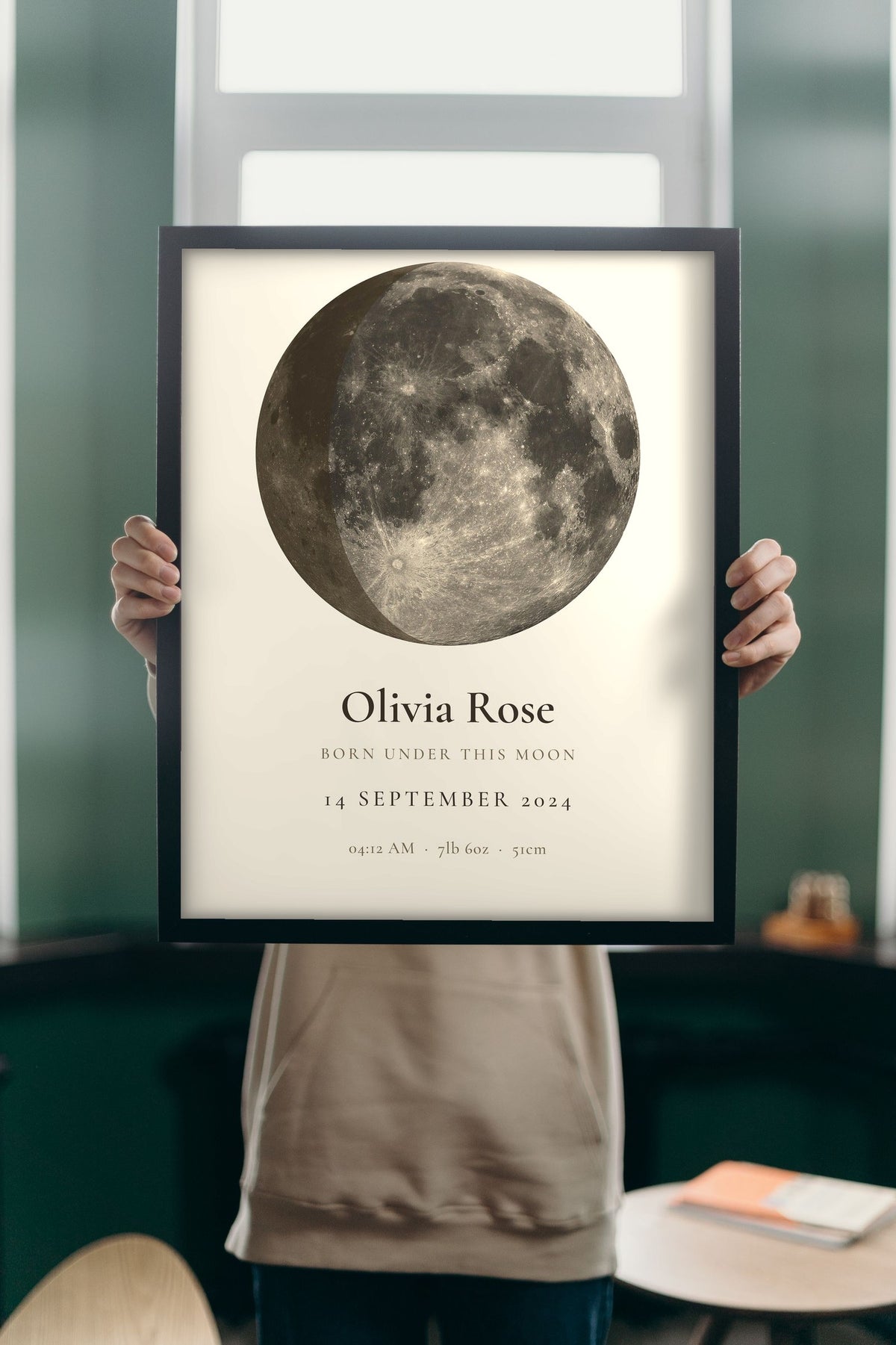 Lifestyle - Personalised New Baby Moon Phase Print held up in a bright room