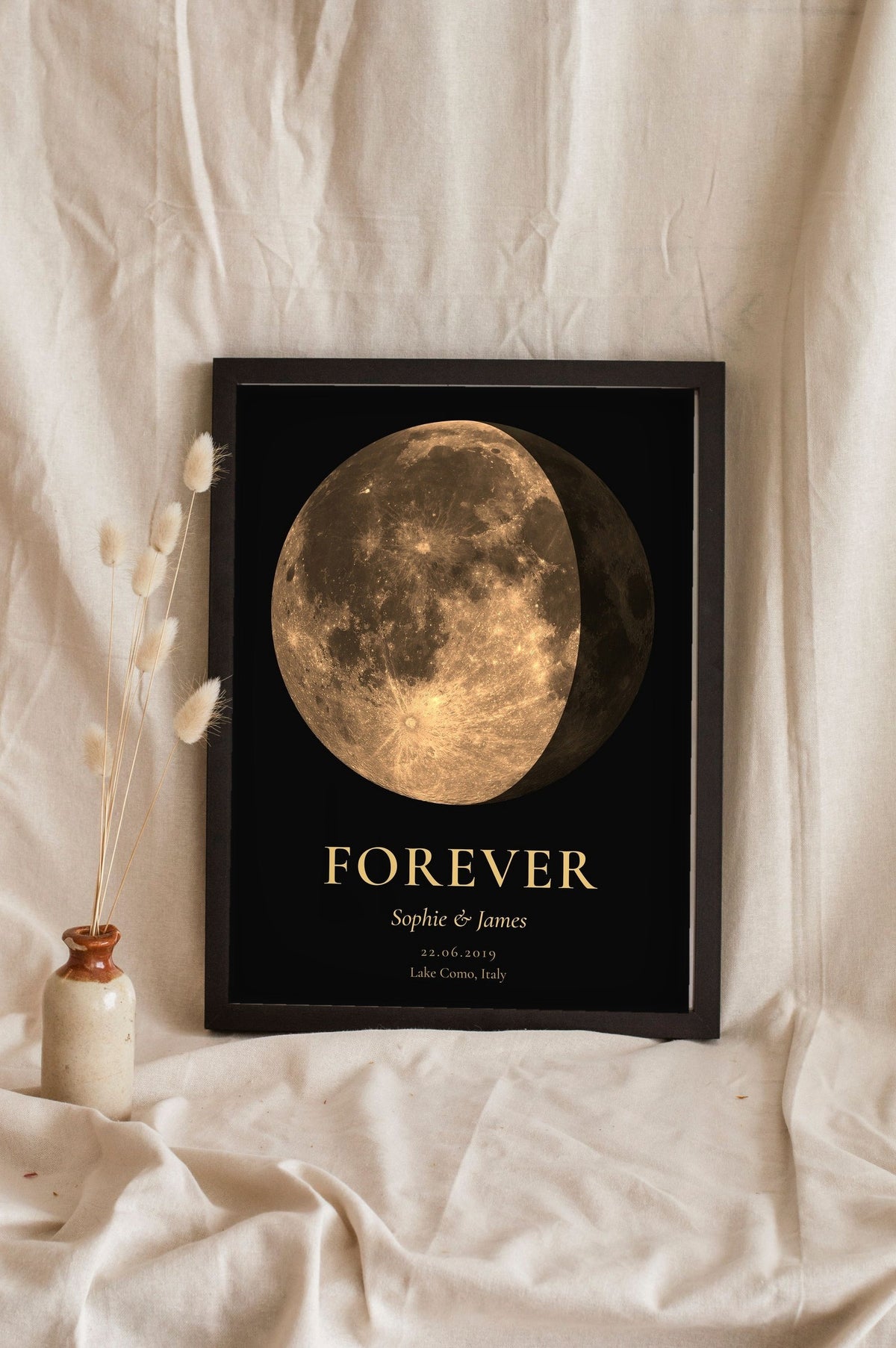 Lifestyle - Personalised Anniversary Moon Phase Print leaning in a frame with dried flowers