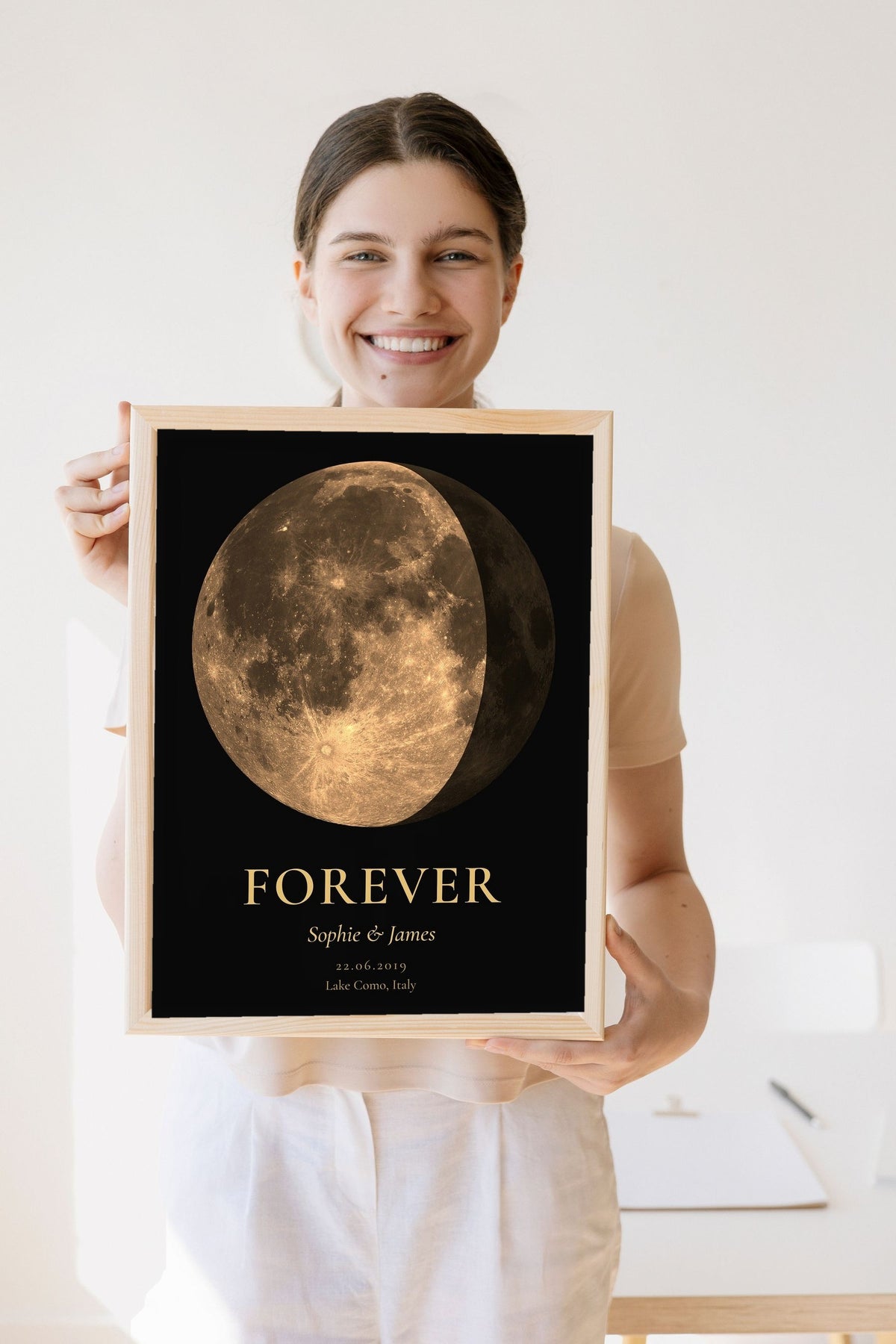 Lifestyle - Personalised Anniversary Moon Phase Print held by a smiling woman
