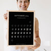 Lifestyle - Personalised Moon Calendar Print held by a smiling woman