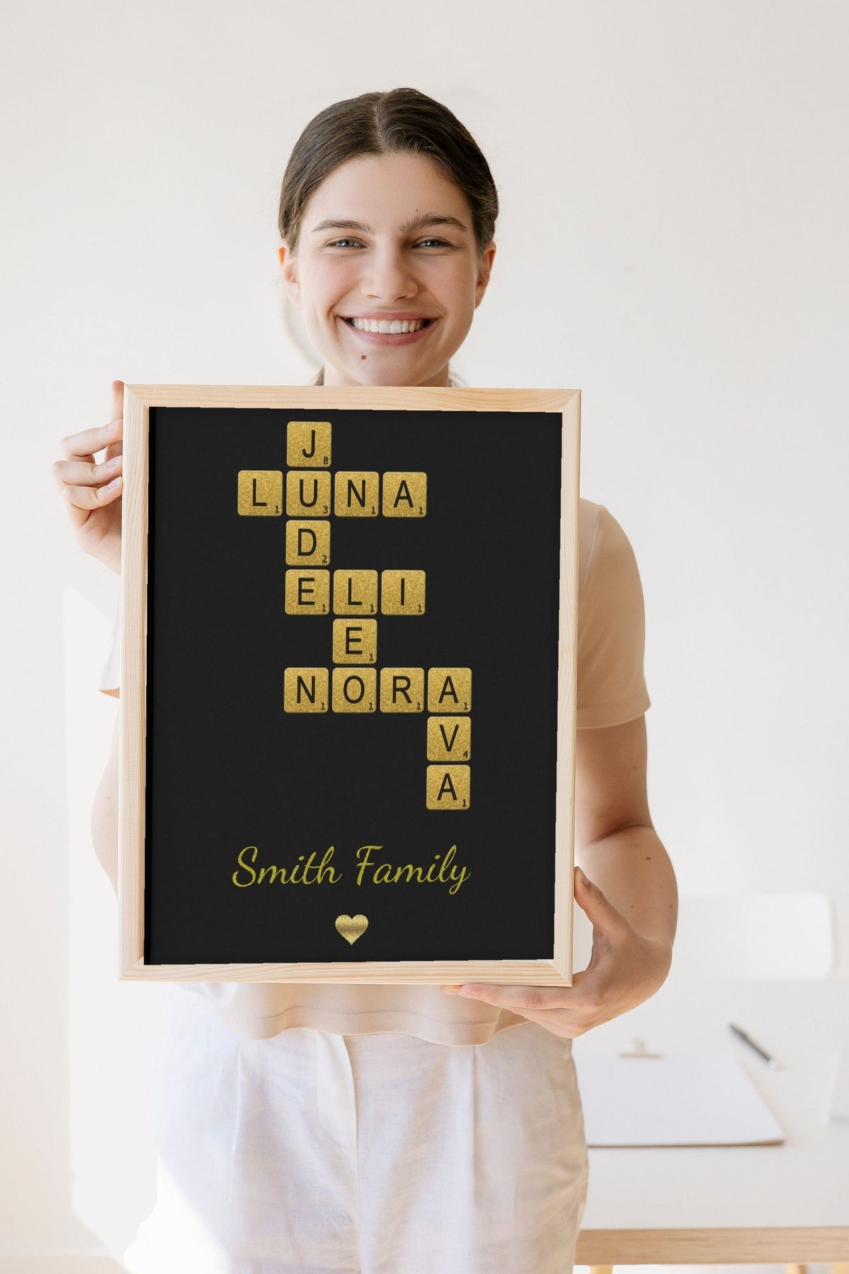 Lifestyle - Personalised Glitter Family Name Scrabble Print held by a smiling woman
