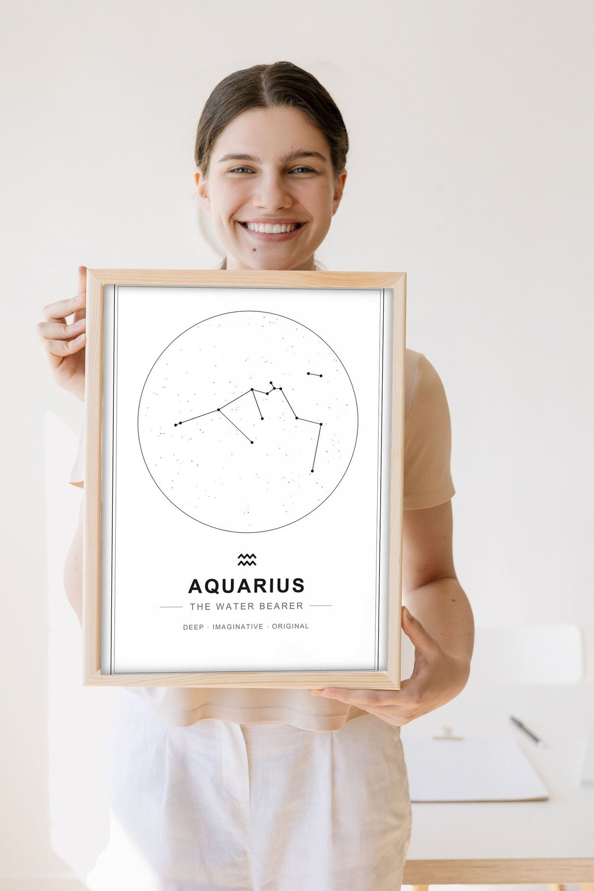 Lifestyle - Personalised Zodiac Star Sign Print held by a smiling woman