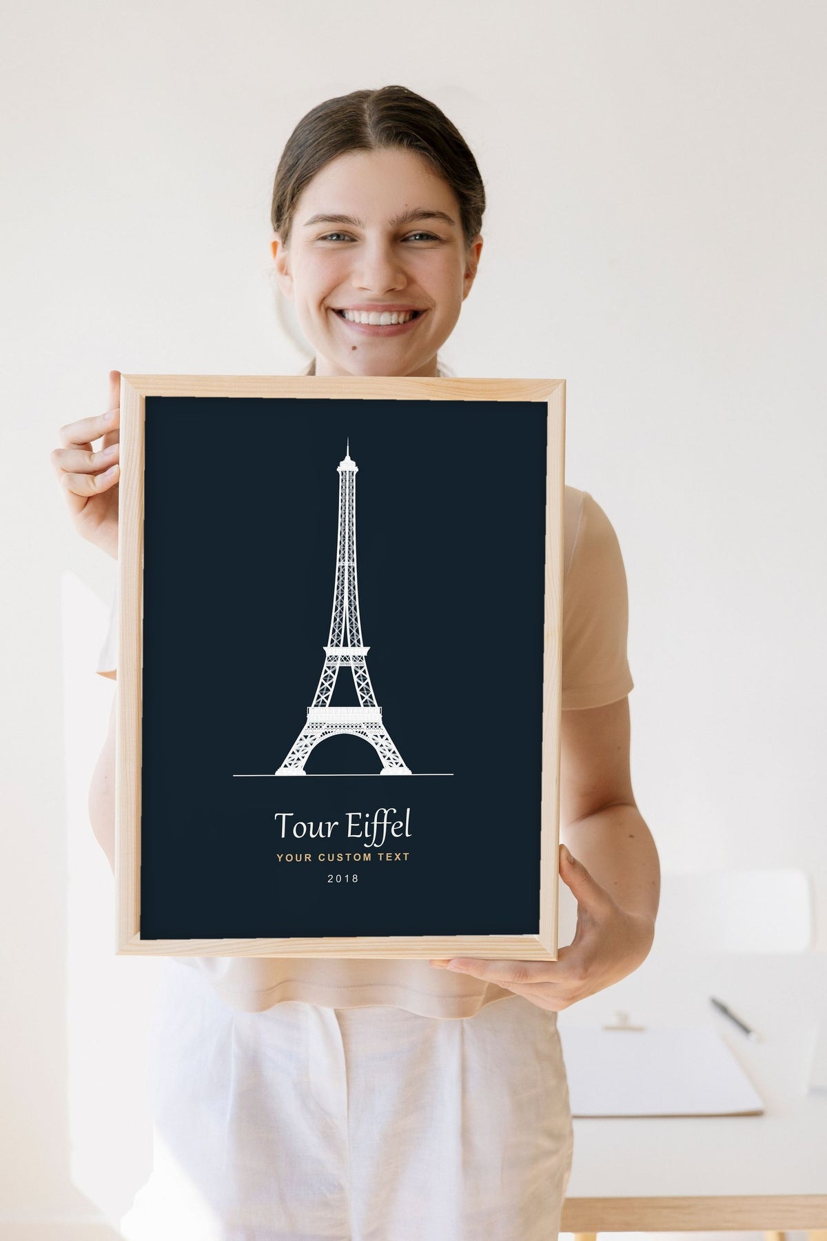Lifestyle - Personalised Eiffel Tower Line Art Print held by a smiling woman