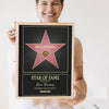 Lifestyle - Personalised Walk of Fame Star Print held by a smiling woman