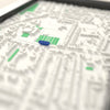 3D Goldington Road Map Framed - Close-up across the 3D map: the real Goldington Road stands with royal blue seats around the green pitch