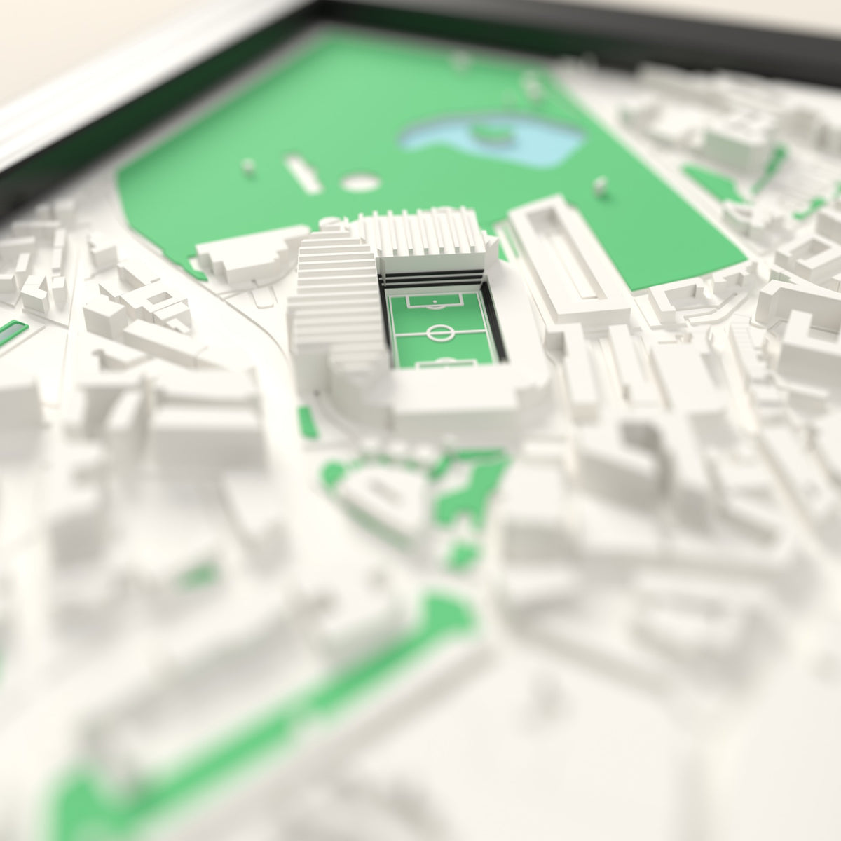 3D St James' Park Map Framed - Close-up across the 3D map: the real St James' Park stands with black seats around the green pitch