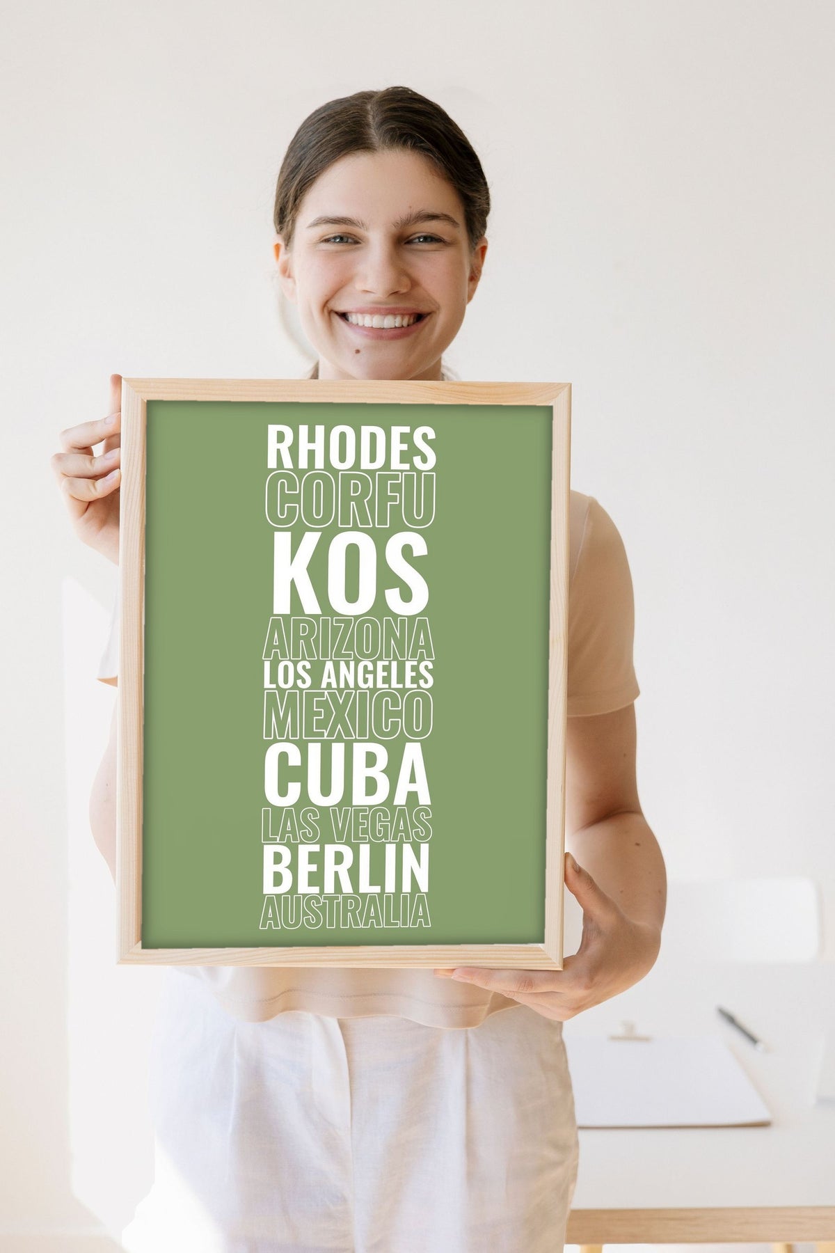 Lifestyle - Personalised Travel Destination Print held by a smiling woman