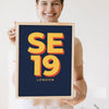 Lifestyle - Personalised Postcode Print held by a smiling woman