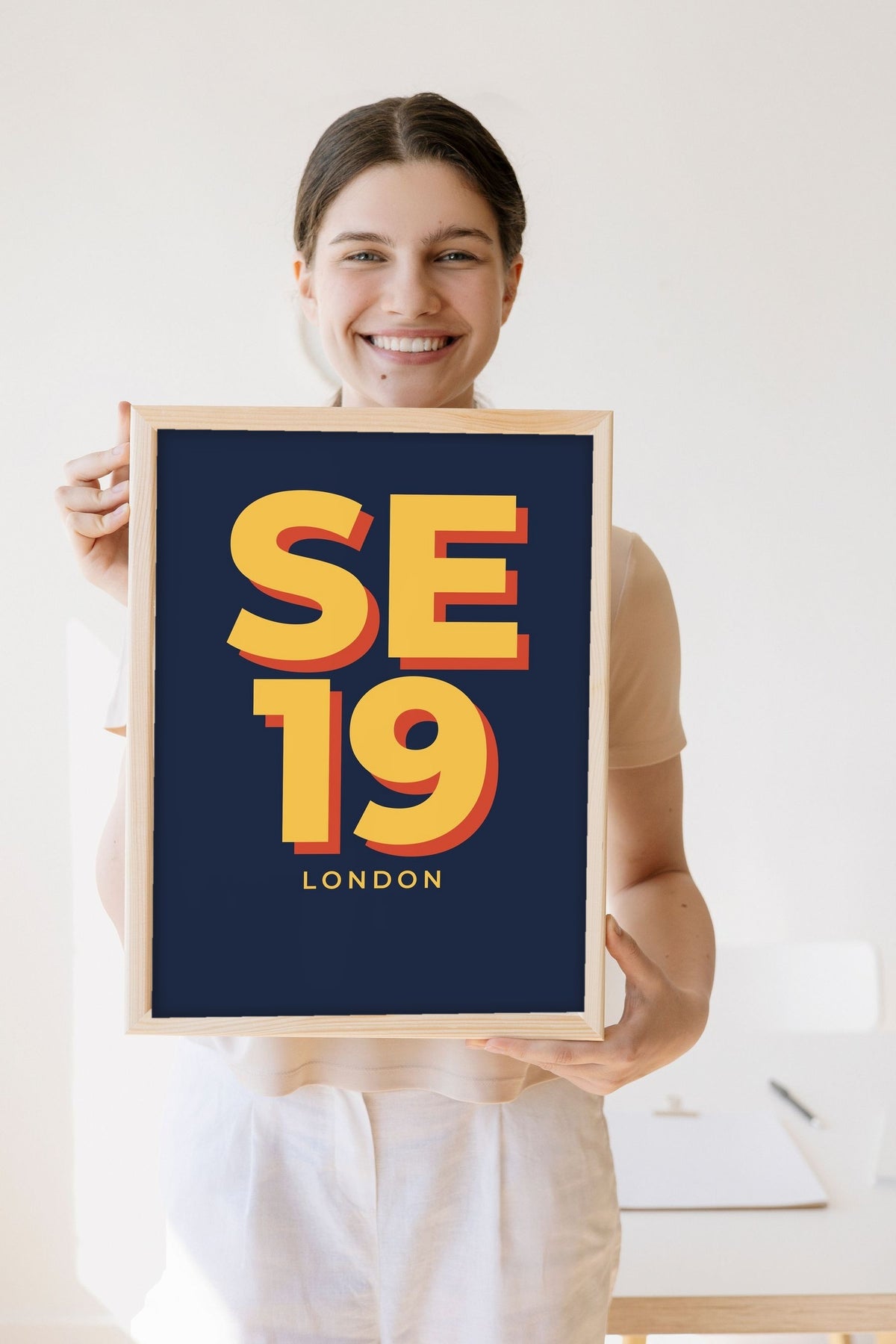 Lifestyle - Personalised Postcode Print held by a smiling woman