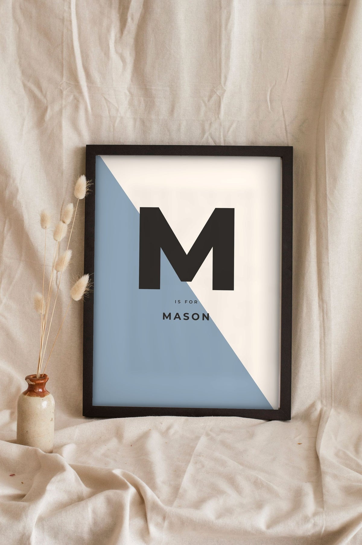 Lifestyle - Personalised Nursery Name Print leaning in a frame with dried flowers
