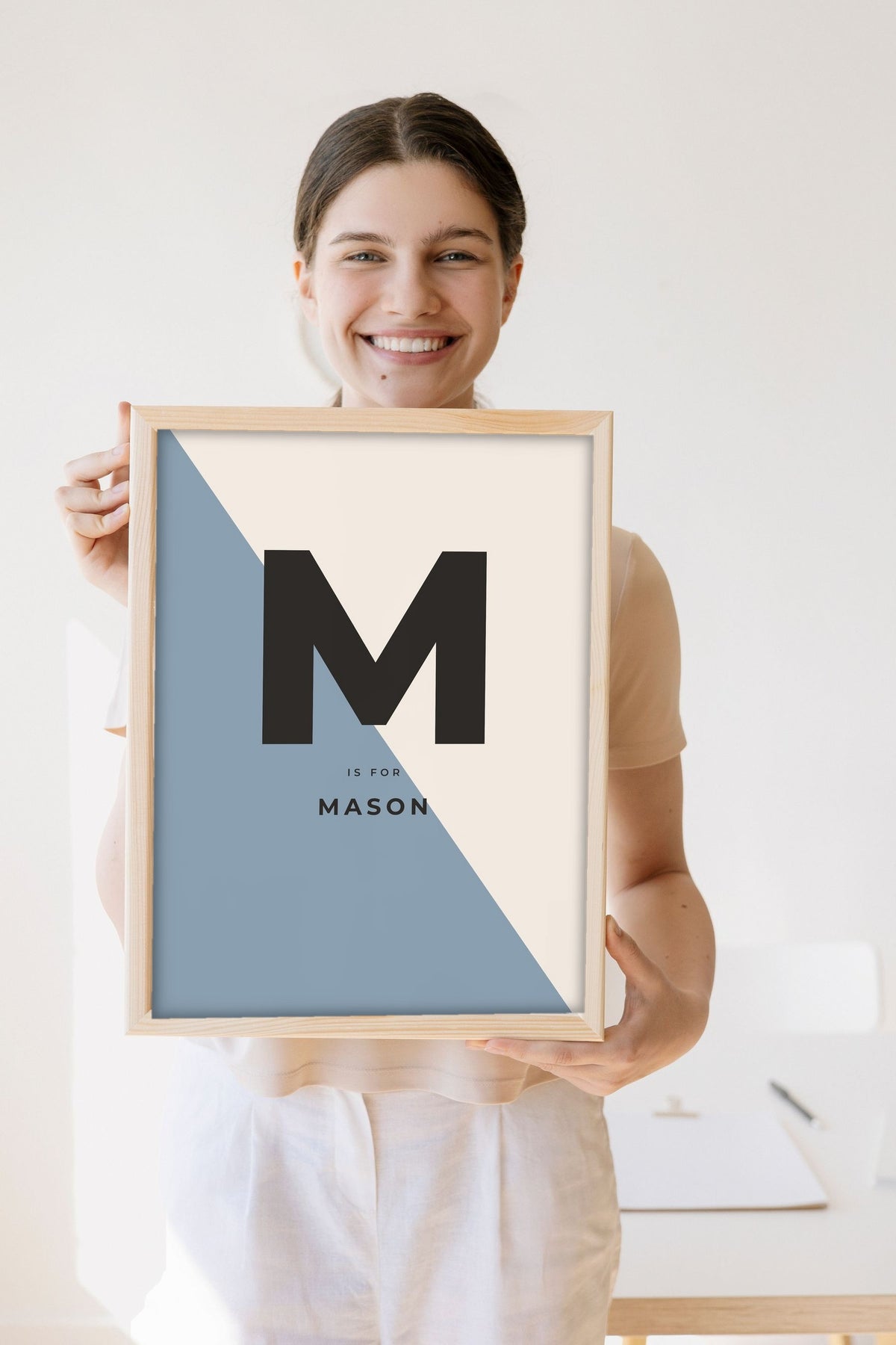 Lifestyle - Personalised Nursery Name Print held by a smiling woman