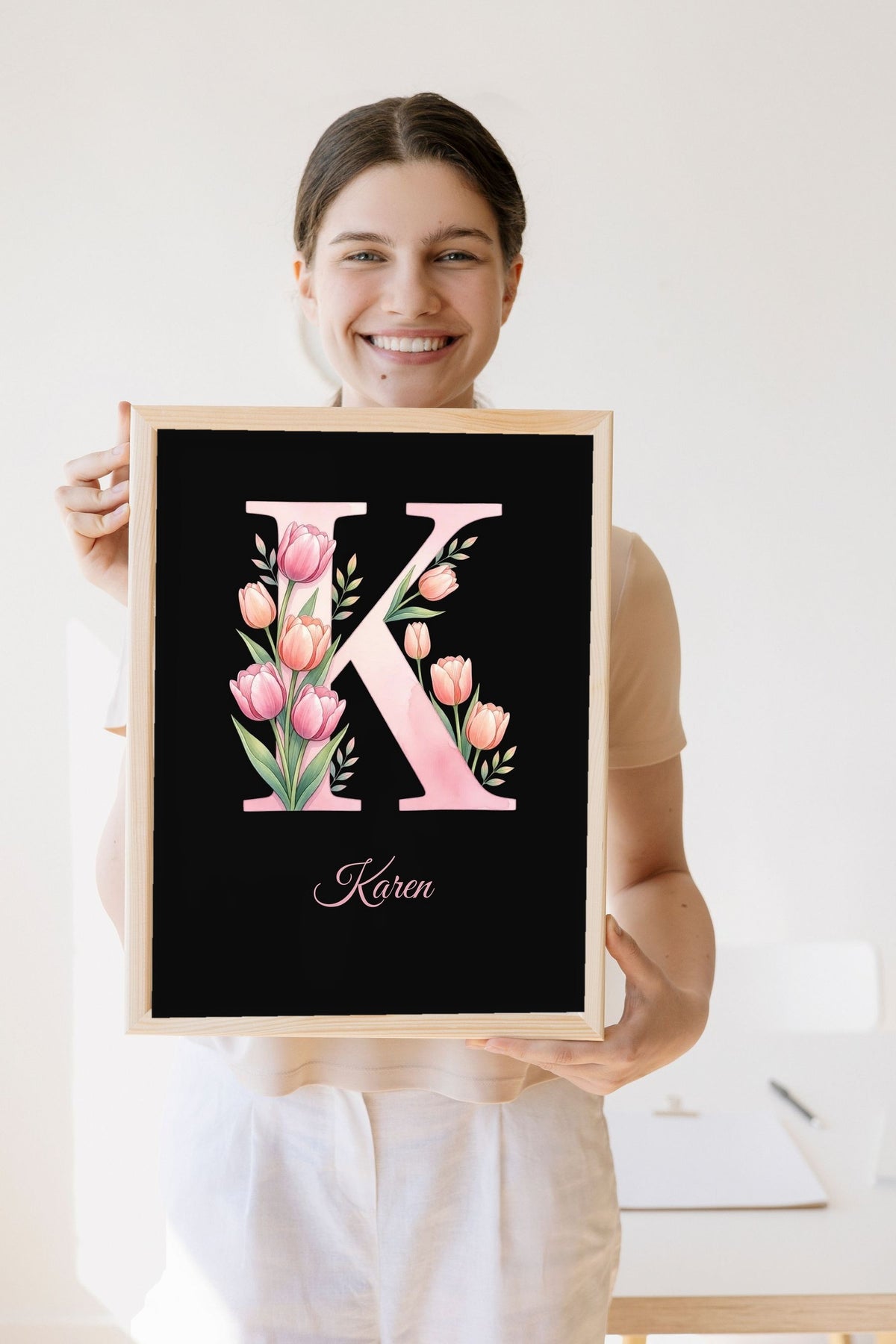Lifestyle - Personalised Floral Initial Print held by a smiling woman