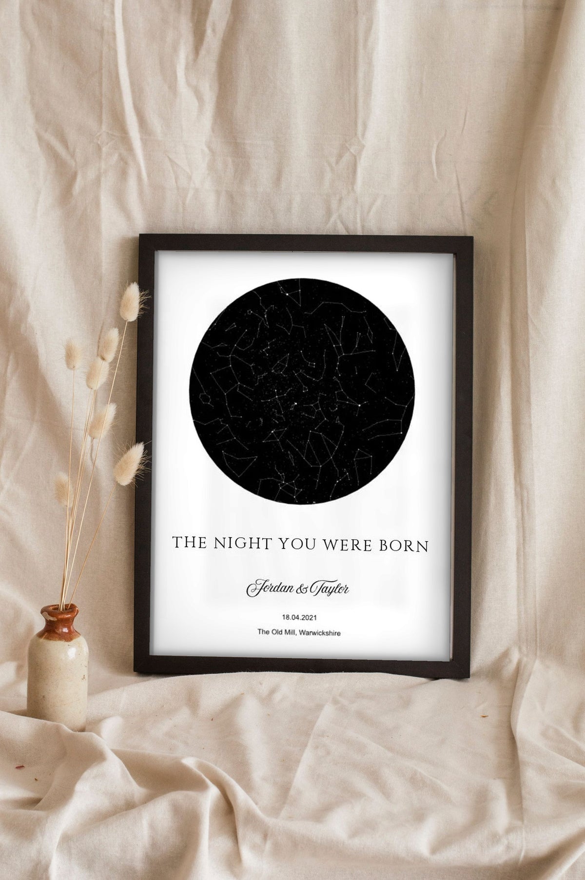 Lifestyle - Personalised The Night You Were Born Star Map Print leaning in a frame with dried flowers