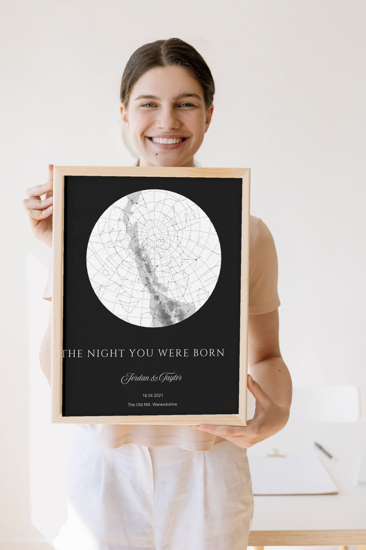 Lifestyle - Personalised The Night You Were Born Star Map Print – Black held by a smiling woman