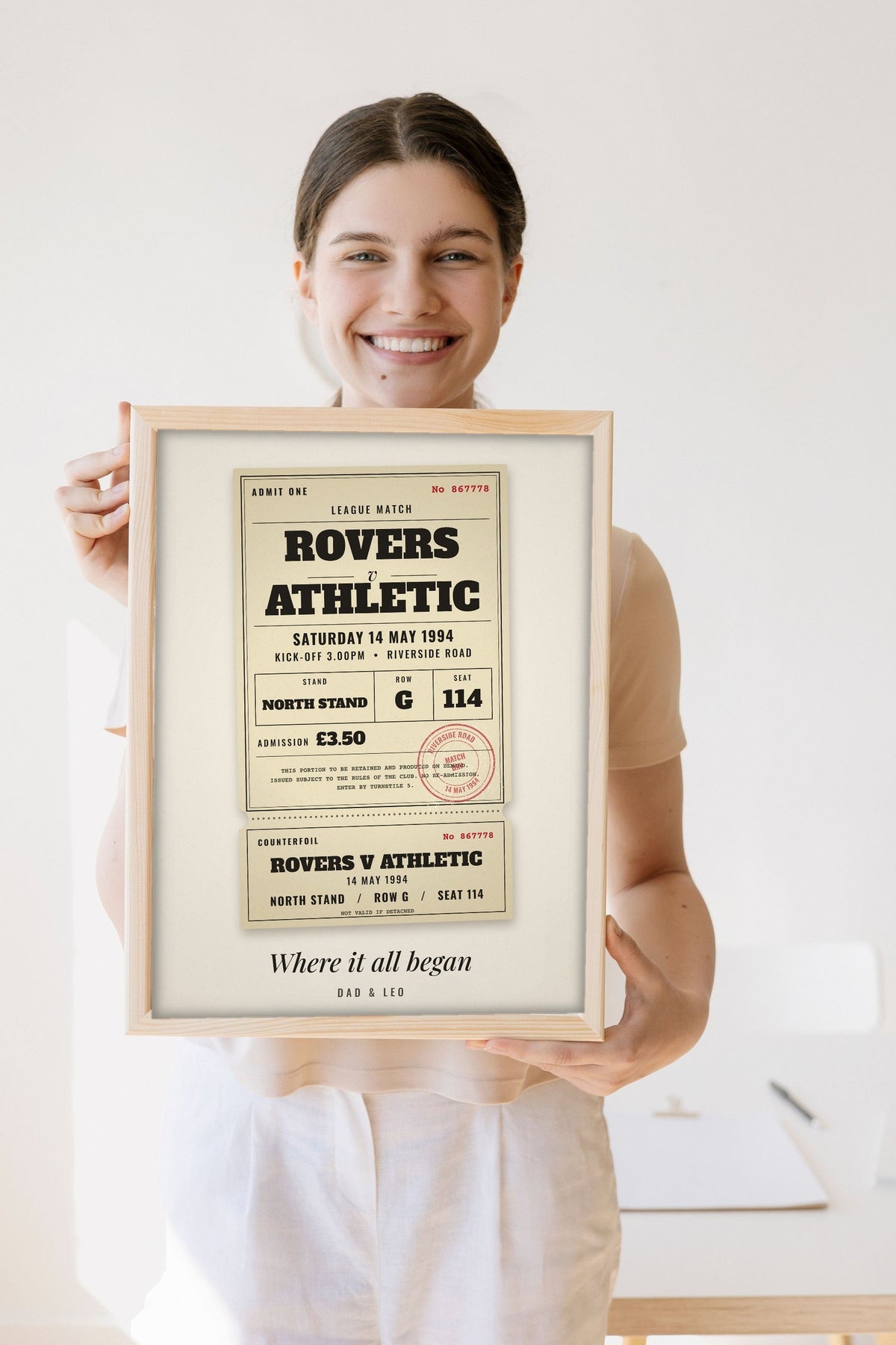 Lifestyle - Personalised Vintage Football Ticket Print held by a smiling woman