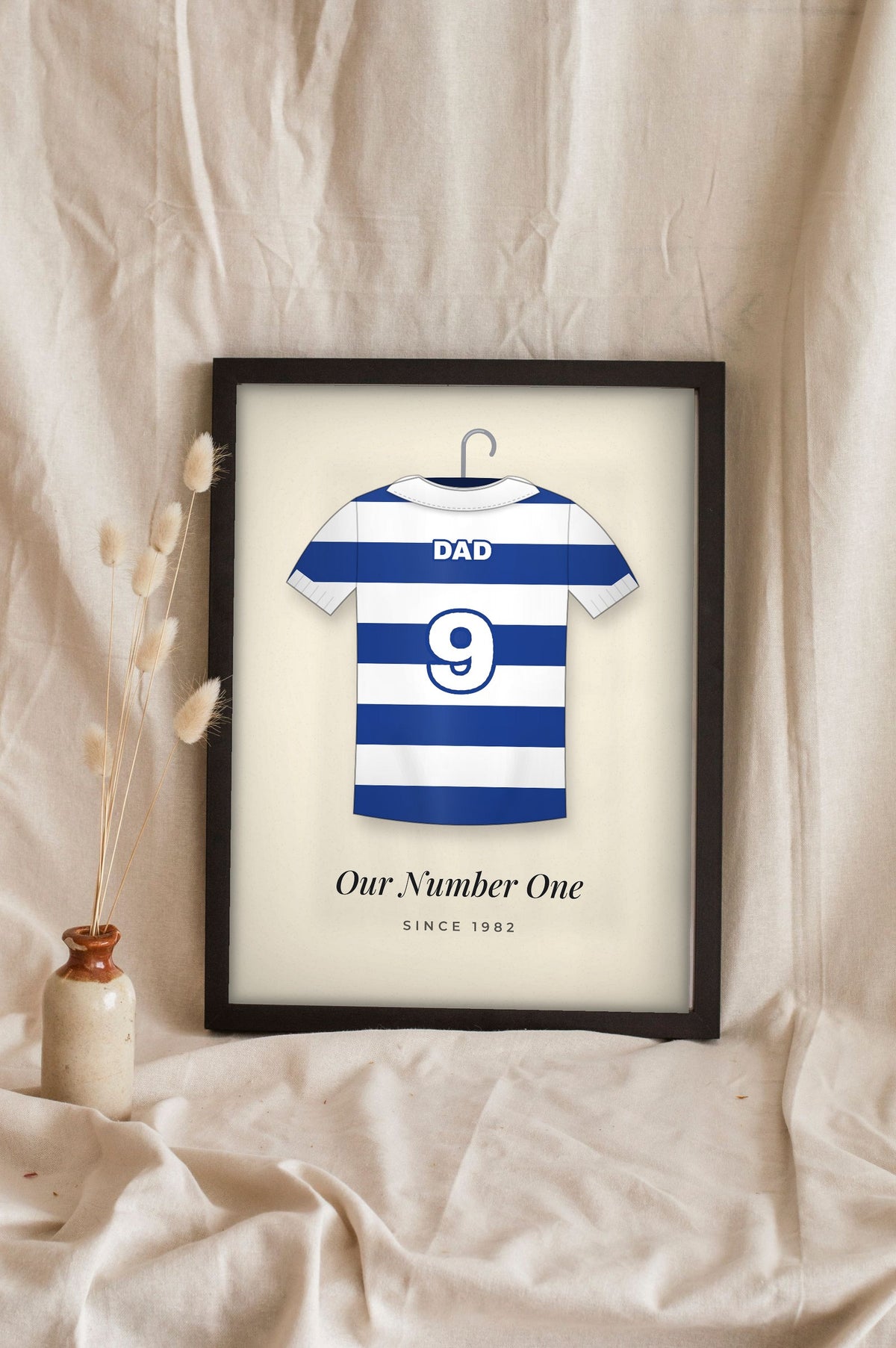 Lifestyle - Personalised Retro Football Shirt Print leaning in a frame with dried flowers
