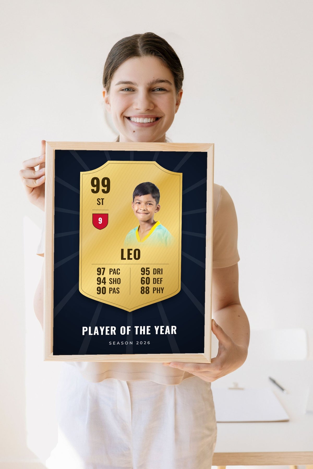Lifestyle - Personalised Football Player Card Print held by a smiling woman