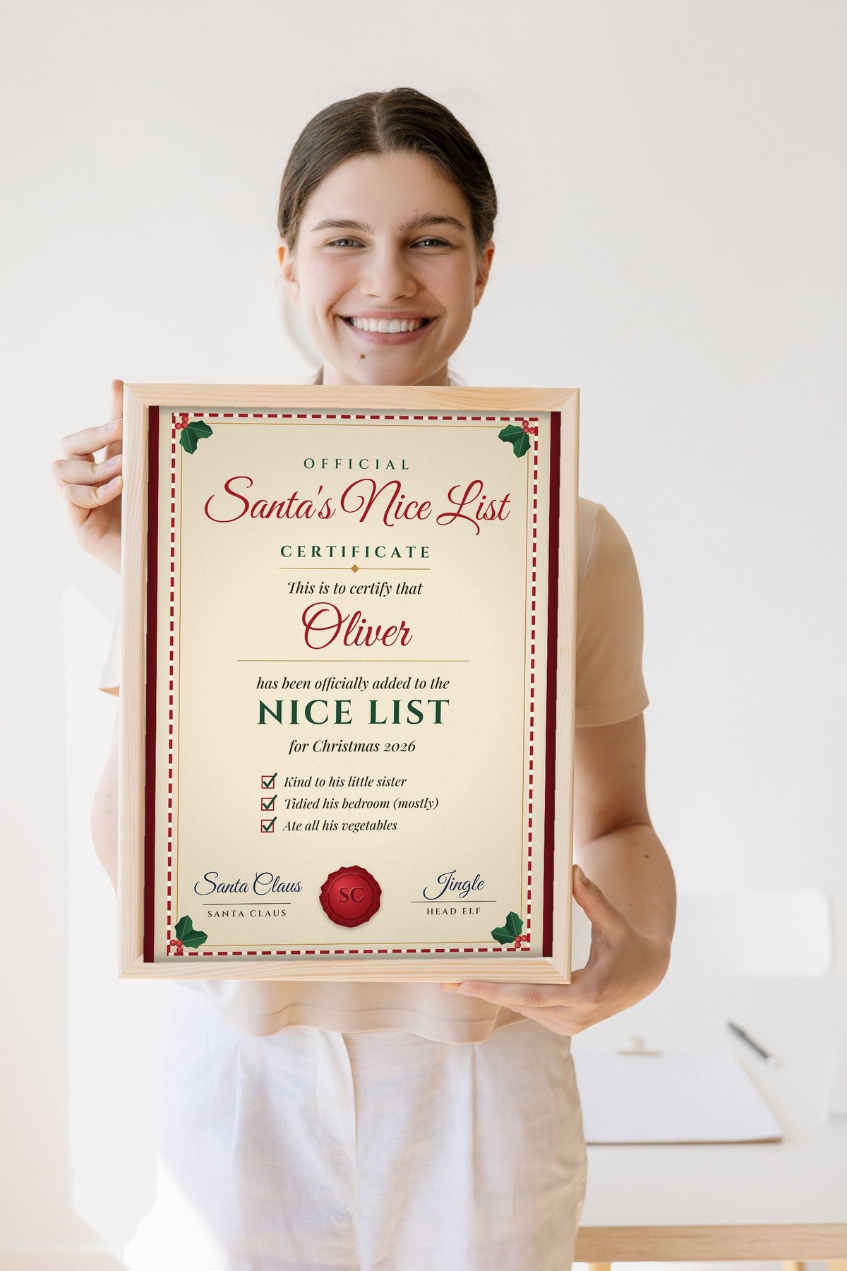 Lifestyle - Personalised Santa's Nice List Certificate Print held by a smiling woman