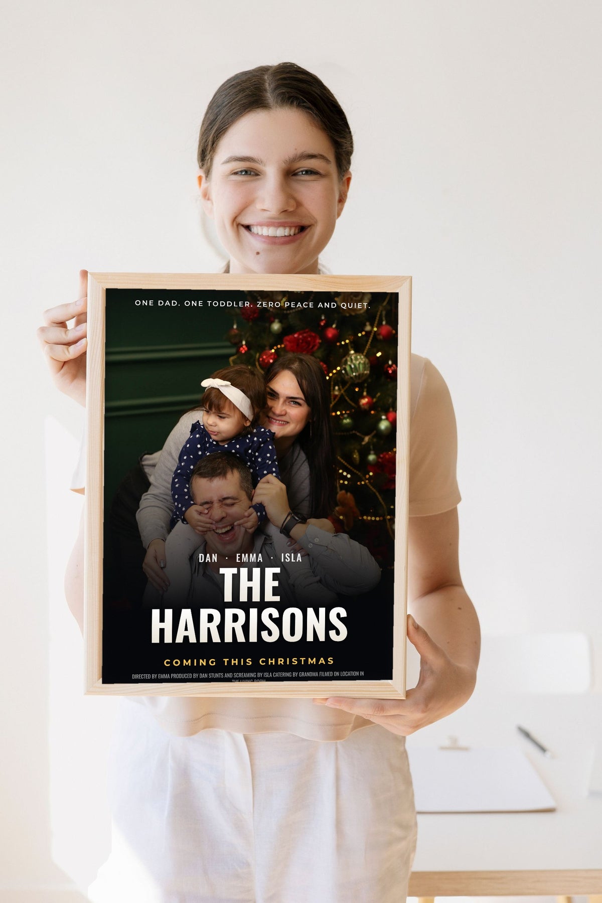Lifestyle - Personalised Family Movie Poster held by a smiling woman