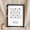 Lifestyle - Personalised Couple Tic Tac Toe Print leaning in a frame with dried flowers