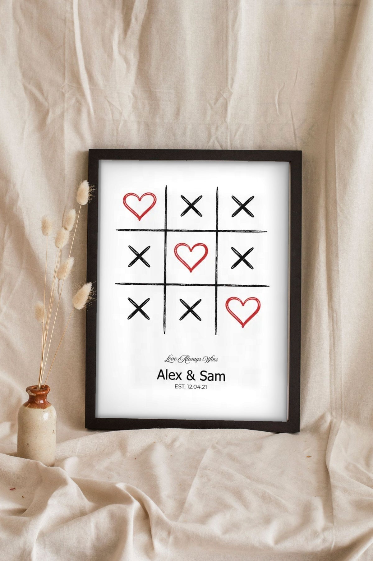 Lifestyle - Personalised Couple Tic Tac Toe Print leaning in a frame with dried flowers