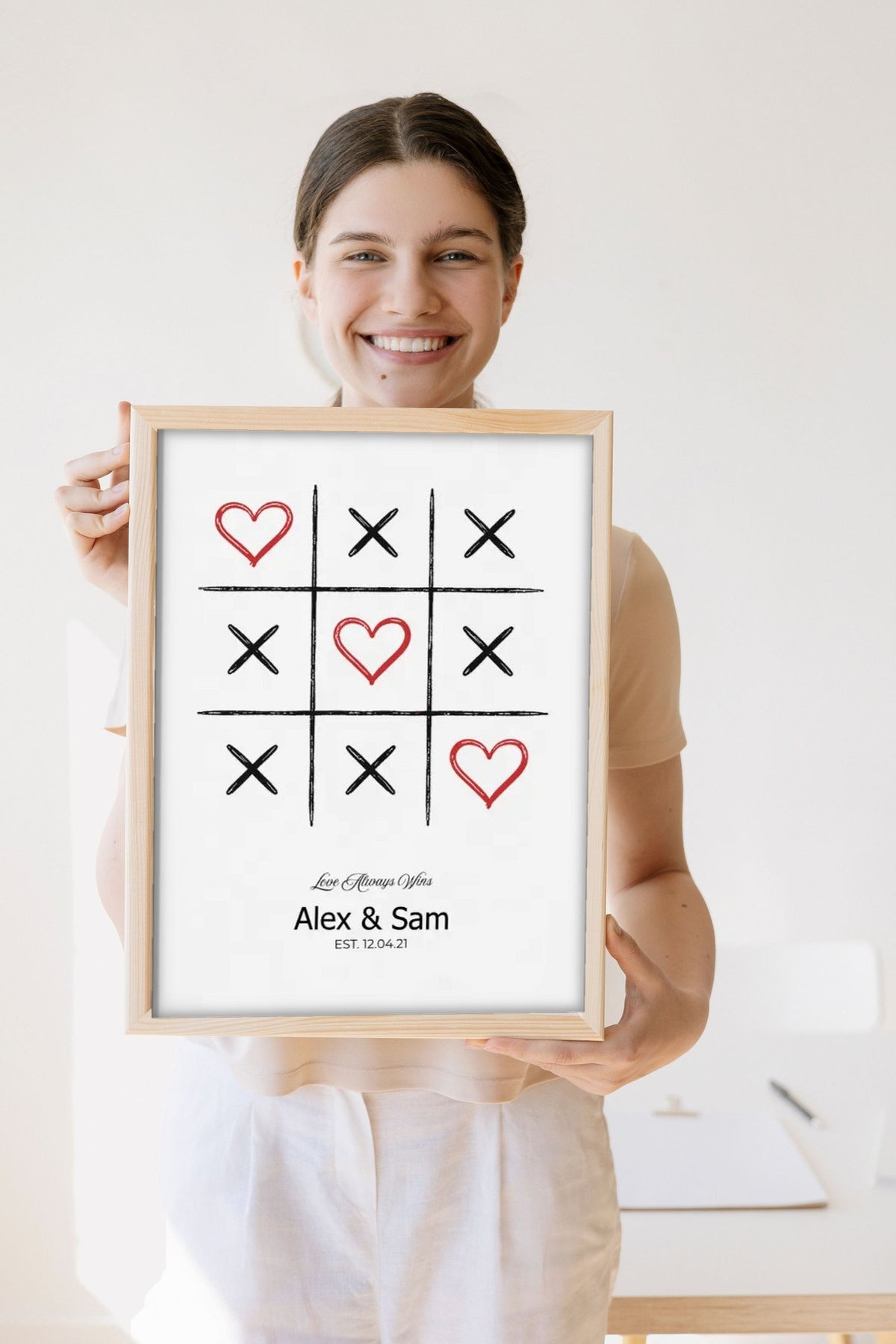 Lifestyle - Personalised Couple Tic Tac Toe Print held by a smiling woman