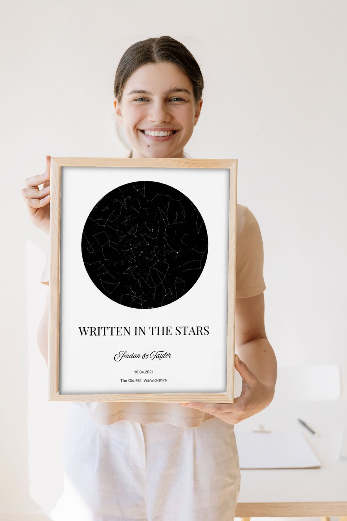 Lifestyle - Personalised Couple Star Map Print held by a smiling woman