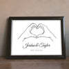 Lifestyle - Personalised Hands Heart Print leaning on a wooden sideboard