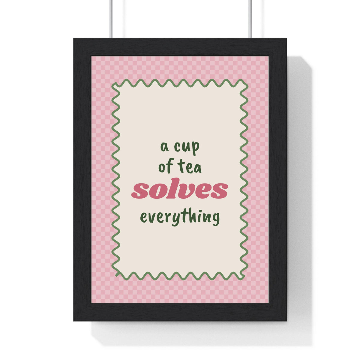 A Cup of Tea Solves Everything Print framed in a black frame, ready to hang