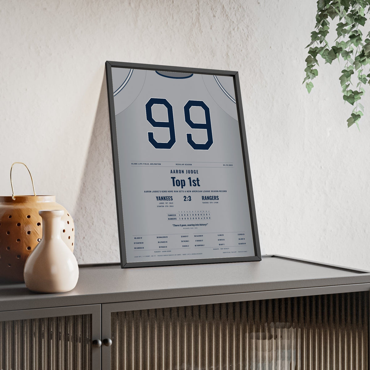 Aaron Judge 2022 62nd Home Run Poster - New York Yankees 99 Jersey Print framed and leaning on a sideboard