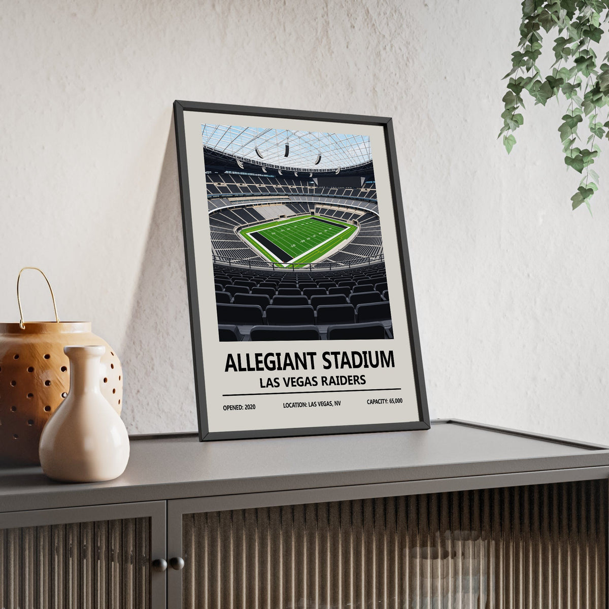 Las Vegas Raiders Allegiant Stadium print framed and leaning on a sideboard