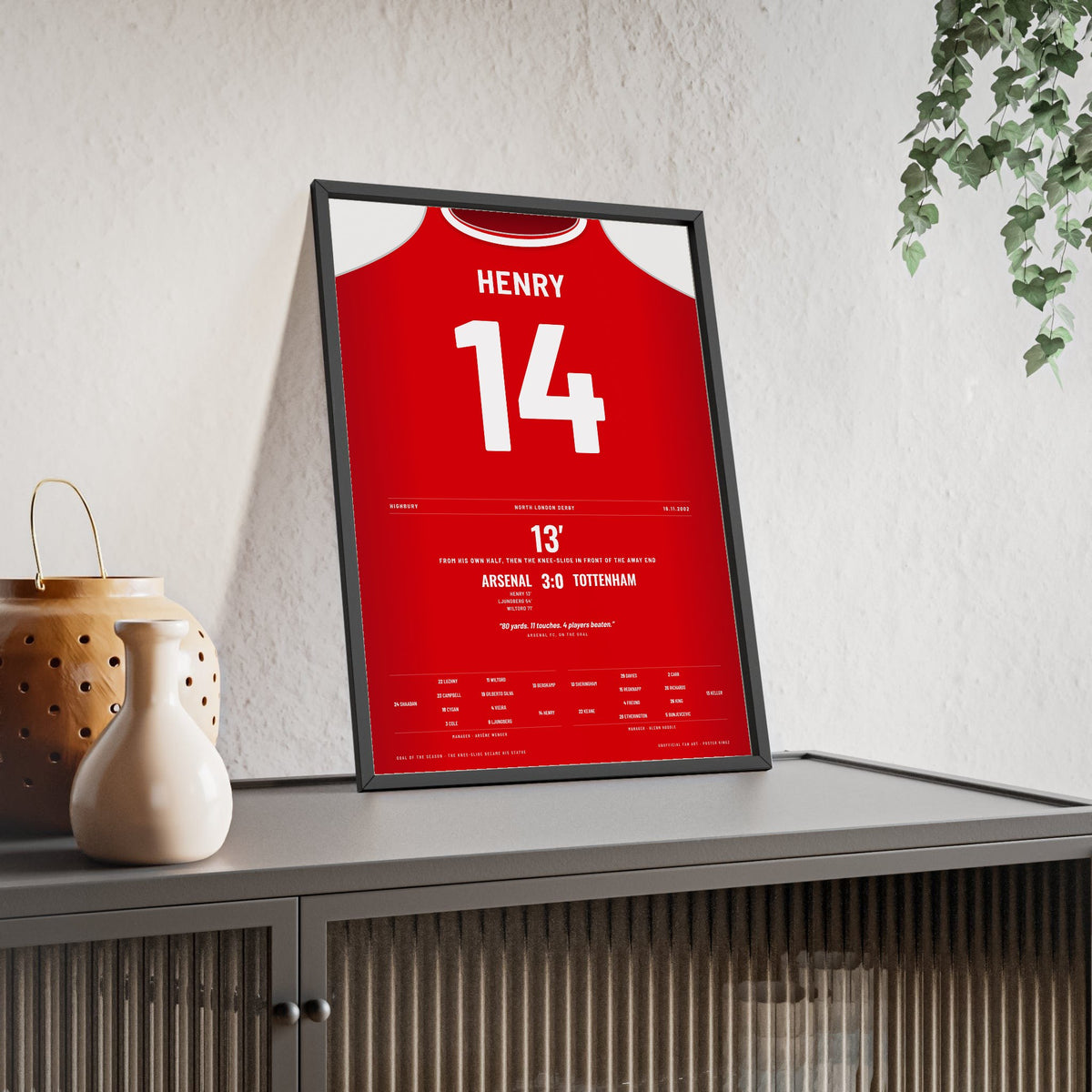 Arsenal Henry Goal v Spurs 2002 Poster - Henry 14 Knee Slide framed and leaning on a sideboard
