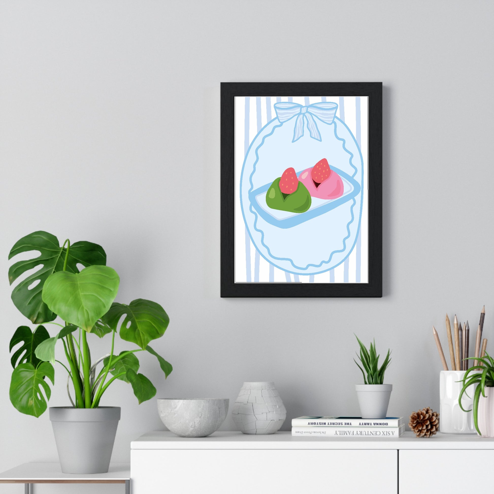Strawberry daifuku poster framed on living room wall above white unit
