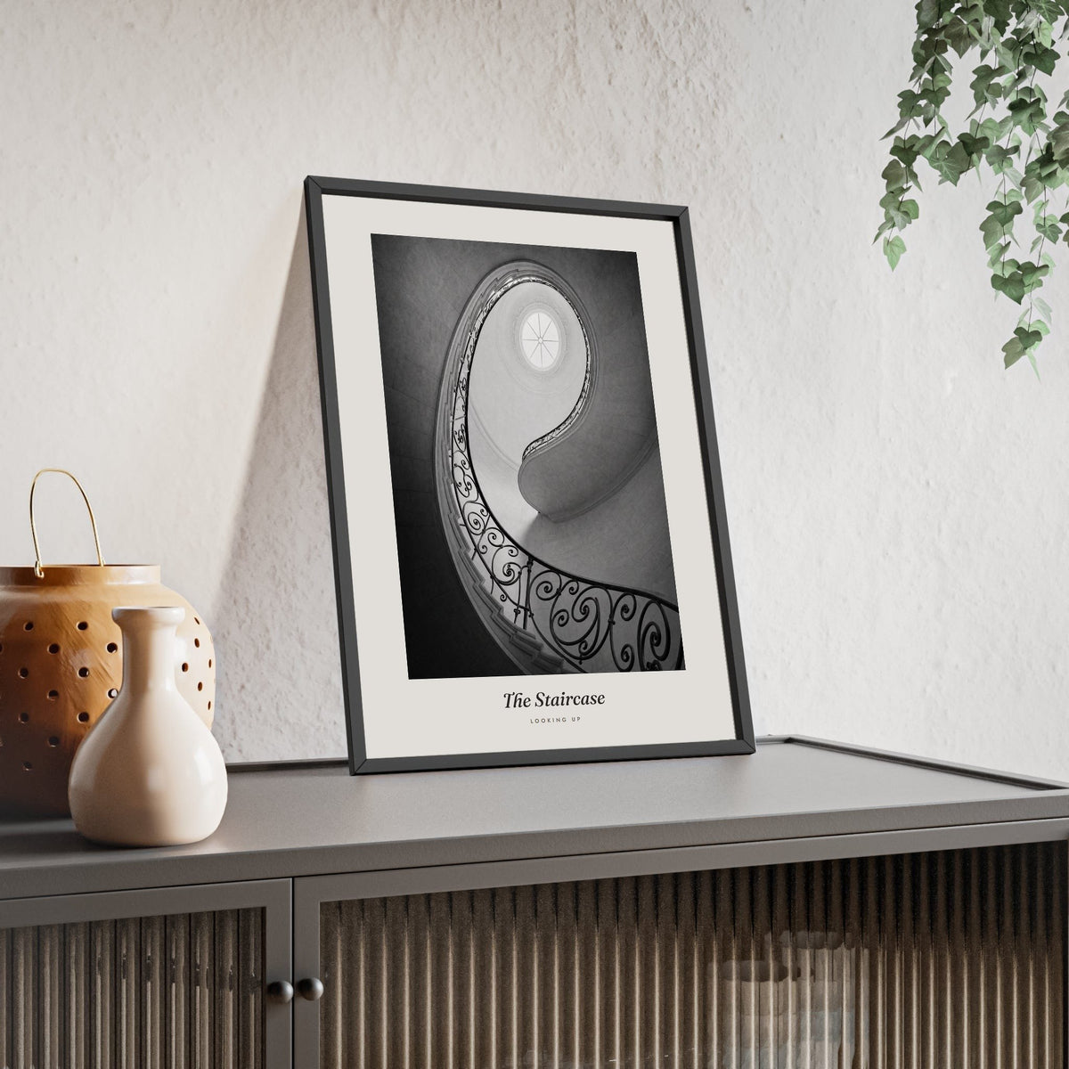 The Staircase Print framed and leaning on a sideboard