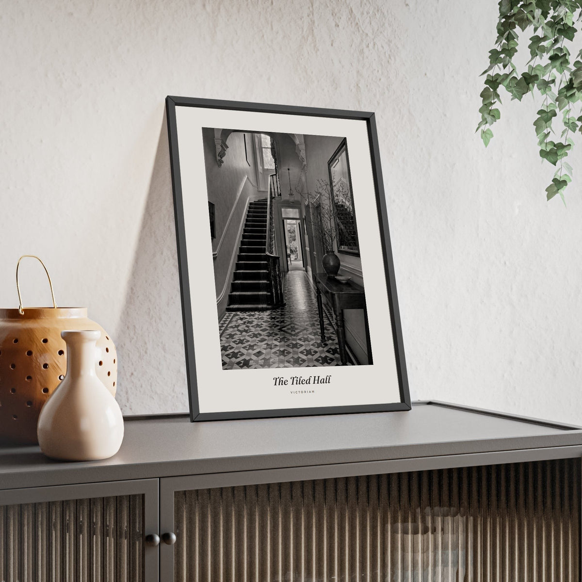 The Tiled Hall Print framed and leaning on a sideboard