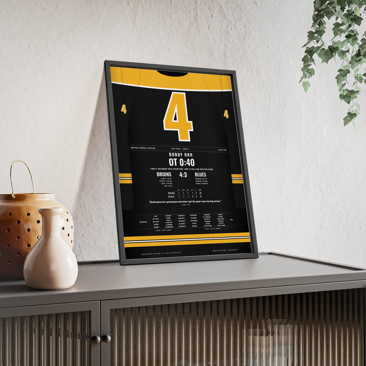 Bobby Orr 1970 Cup Final Overtime Goal Poster - Boston Bruins 4 Hockey Jersey Print framed and leaning on a sideboard