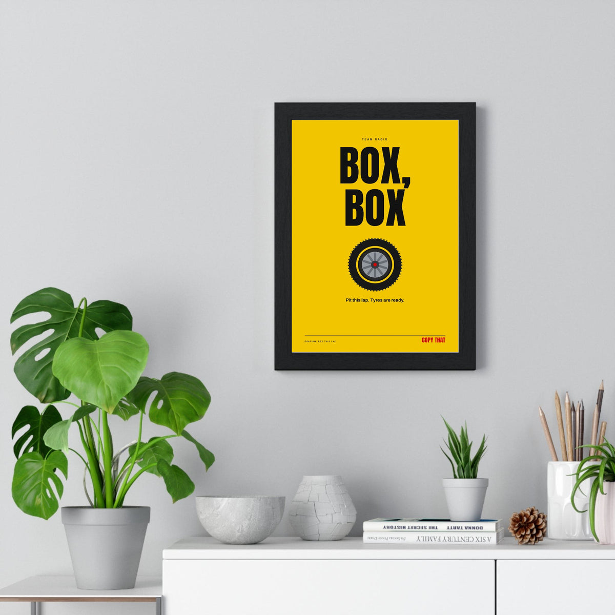 Box Box Racing print framed on a living room wall