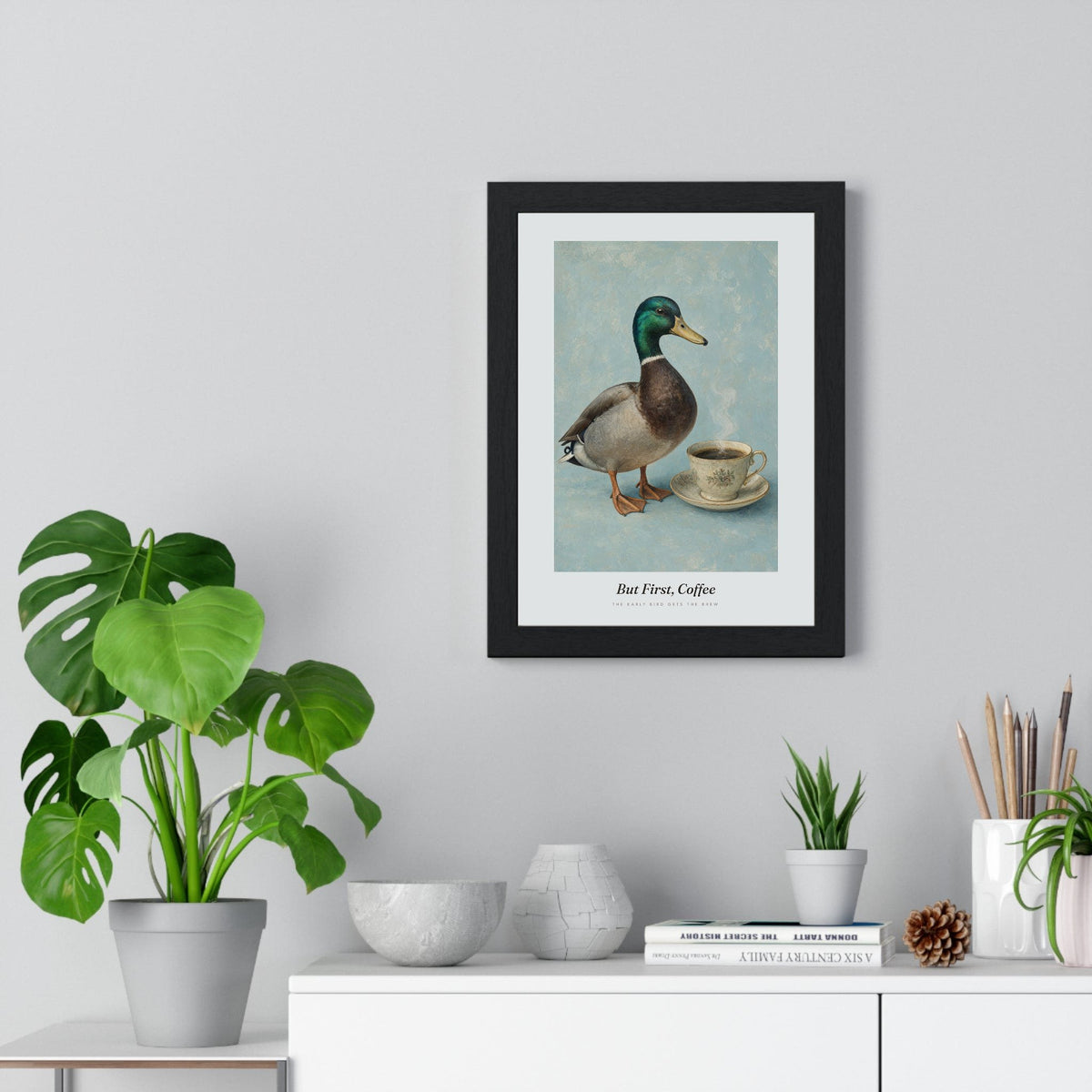 But First Coffee Duck Print framed on a living room wall