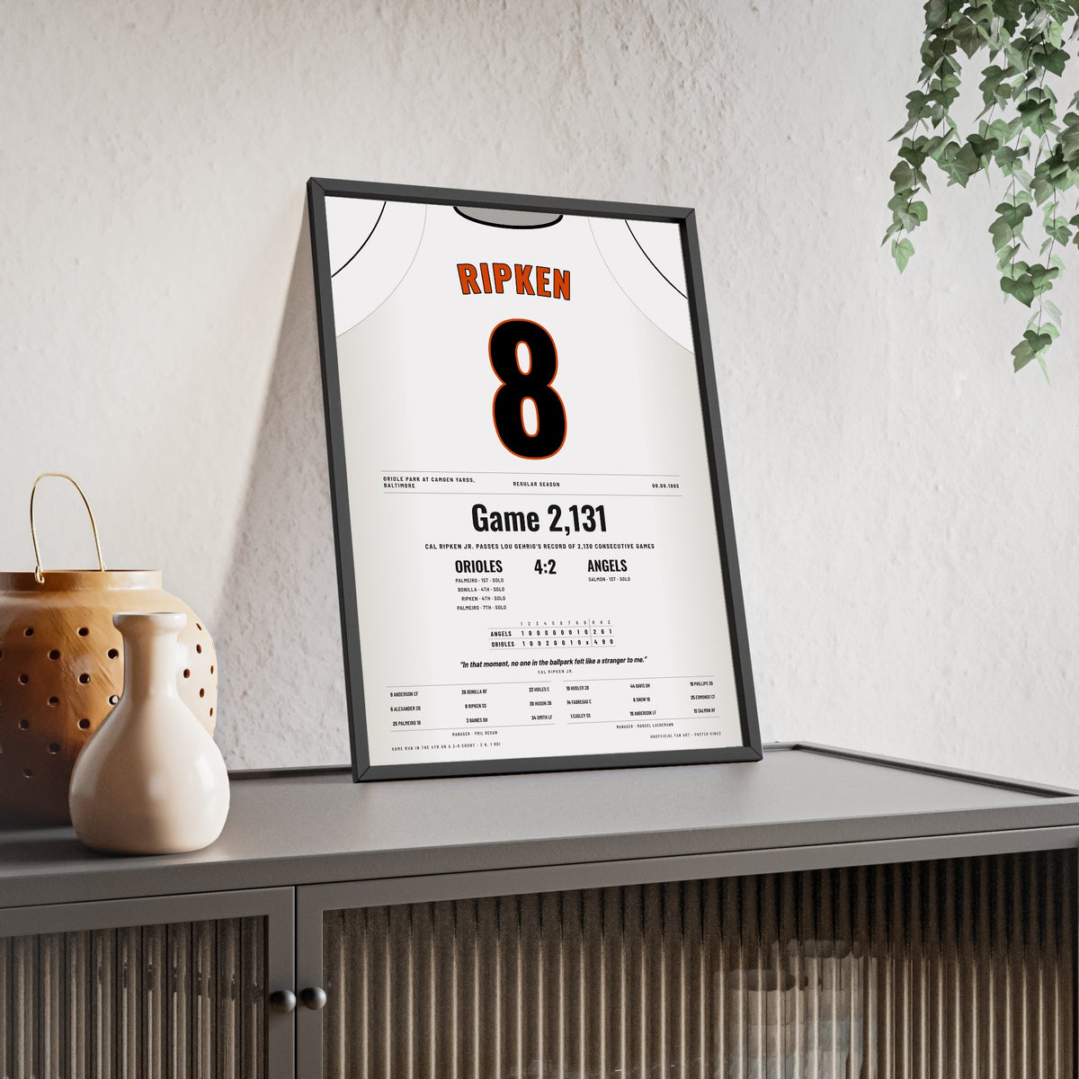 Cal Ripken Jr. 1995 2,131st Consecutive Game Poster - Baltimore Orioles 8 Jersey Print framed and leaning on a sideboard