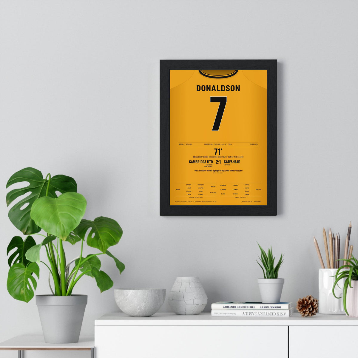 Cambridge United Play-Off Final 2014 Poster - Ryan Donaldson 7 Wembley Shirt Print framed on a living room wall