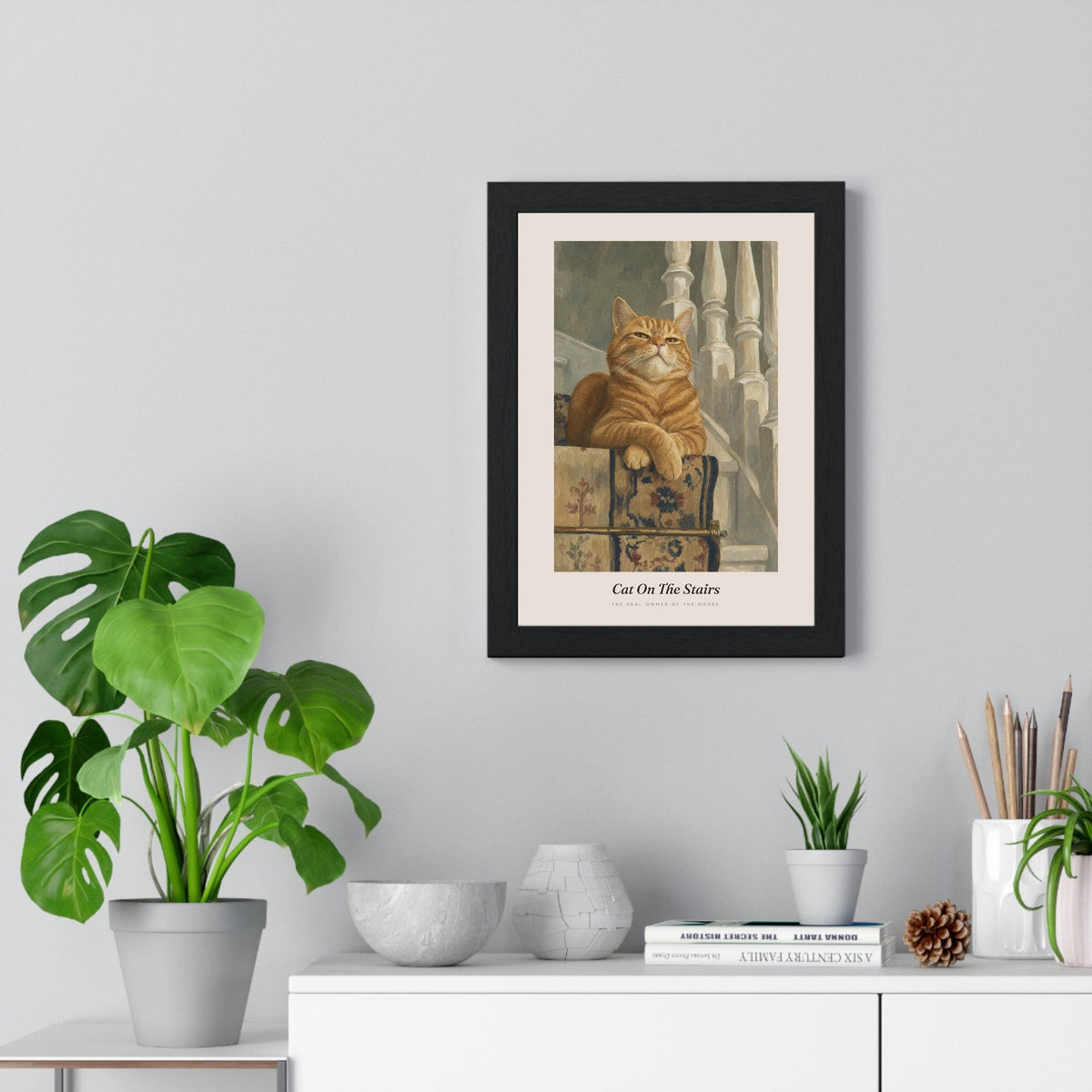 Cat on the Stairs Print framed on a living room wall