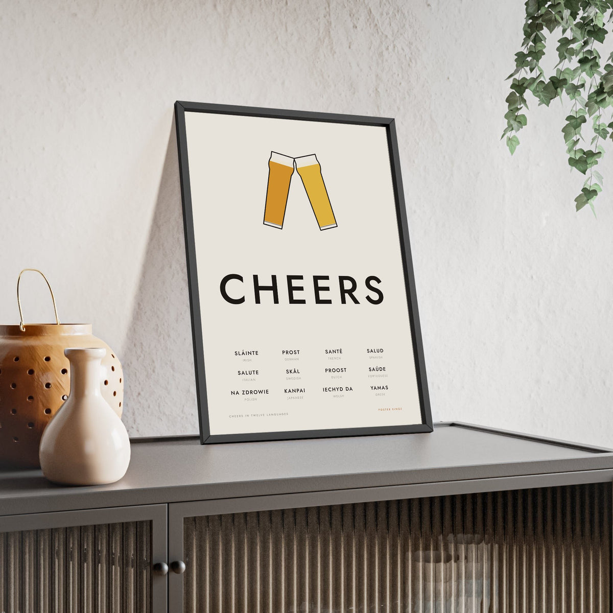 Cheers In Different Languages Print framed and leaning on a sideboard