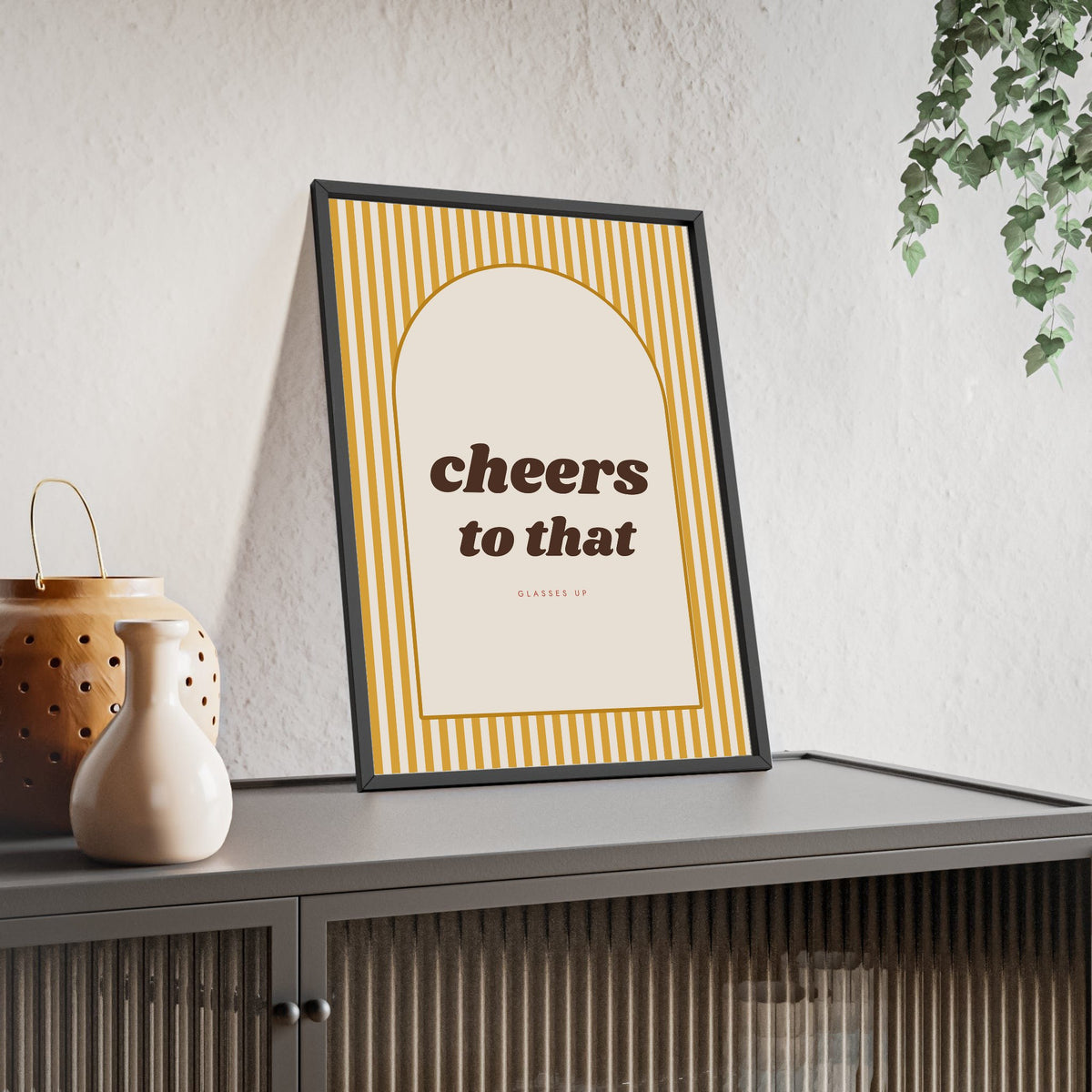 Cheers to That Print framed and leaning on a sideboard