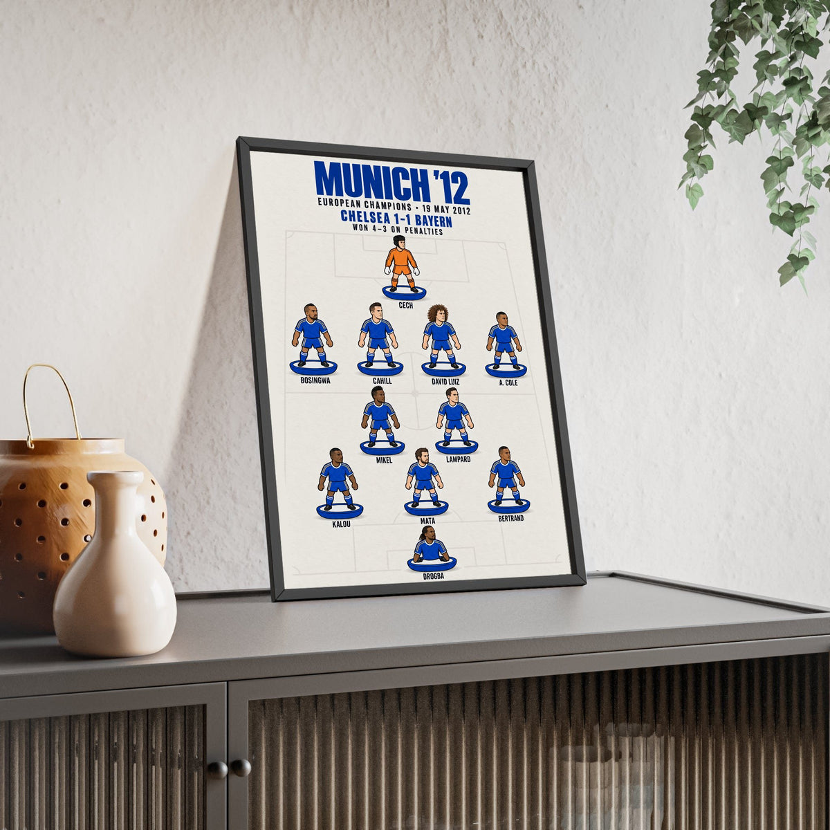Chelsea Munich 2012 XI framed print leaning on a sideboard